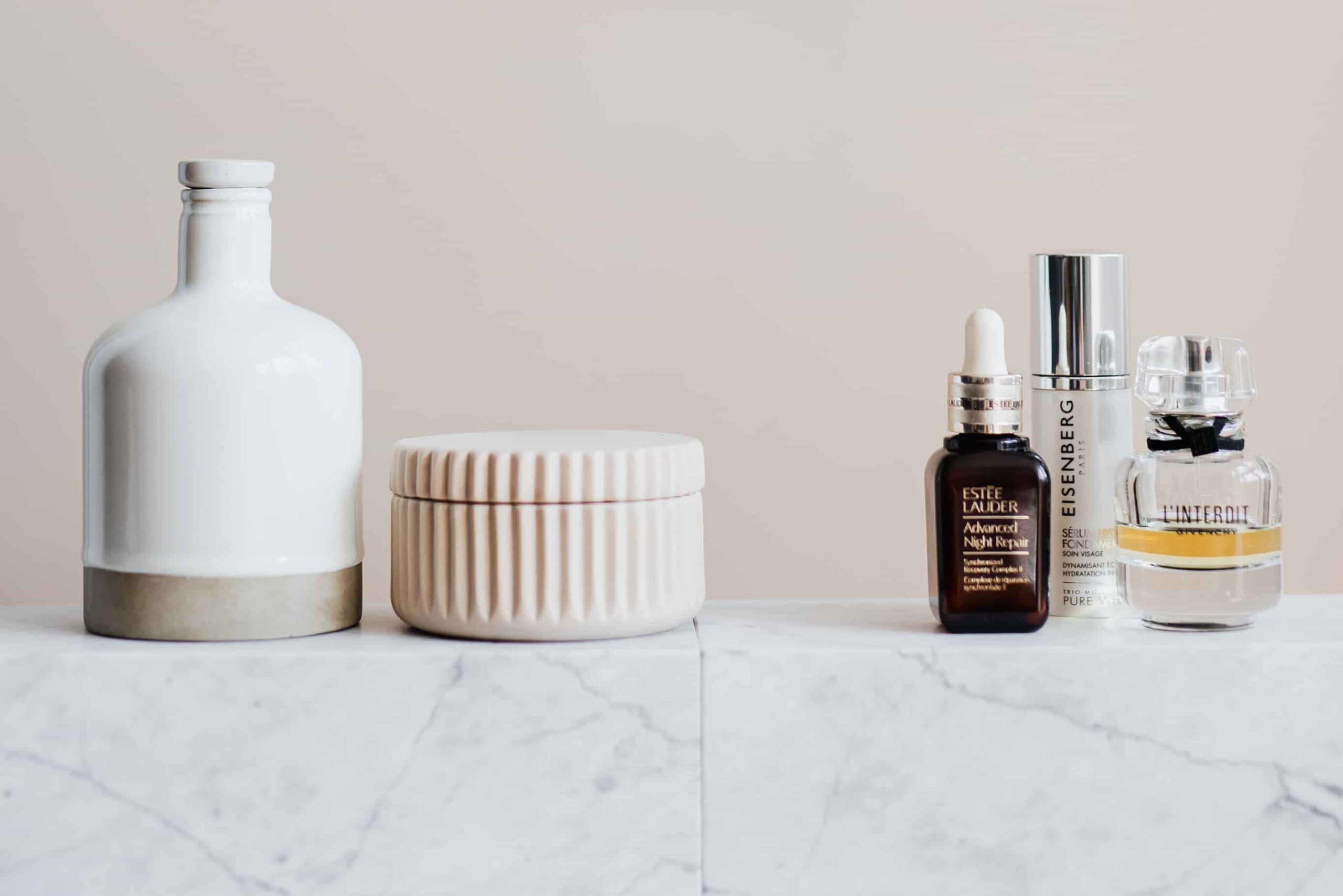 Beauty products on a marble counter.